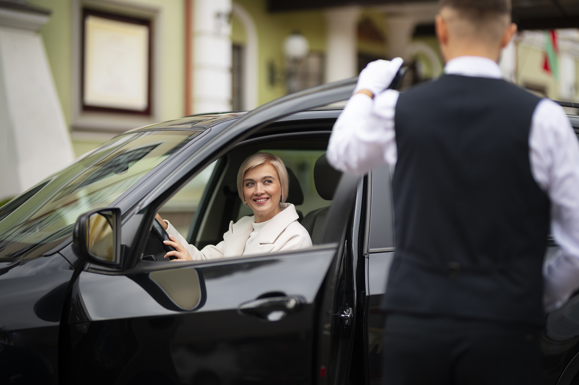parking-valet-helping-woman-park-her-car
